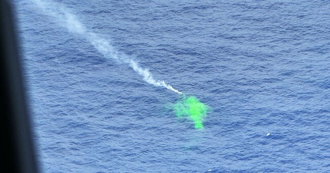 バスクリンのような蛍光着色料が海面に撒かれ、発煙筒も焚かれている