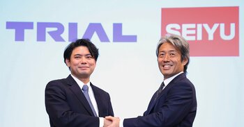 記者会見後、握手するトライアルホールディングス（HD）の永田洋幸取締役と西友の野村優執行役員