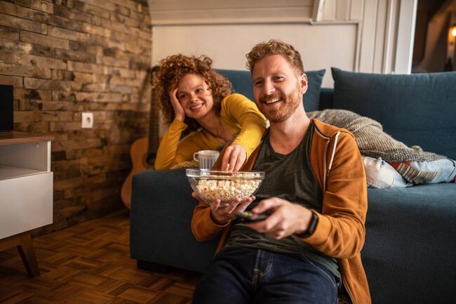 young couple watching a movie at home