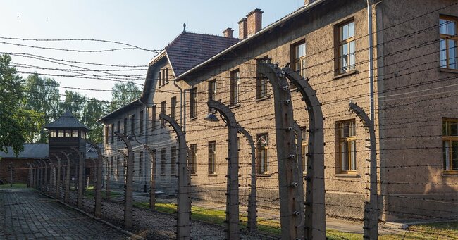 アウシュビッツ・ビルケナウ強制収容所の有刺鉄線のフェンスに囲まれたレンガ造りの建物