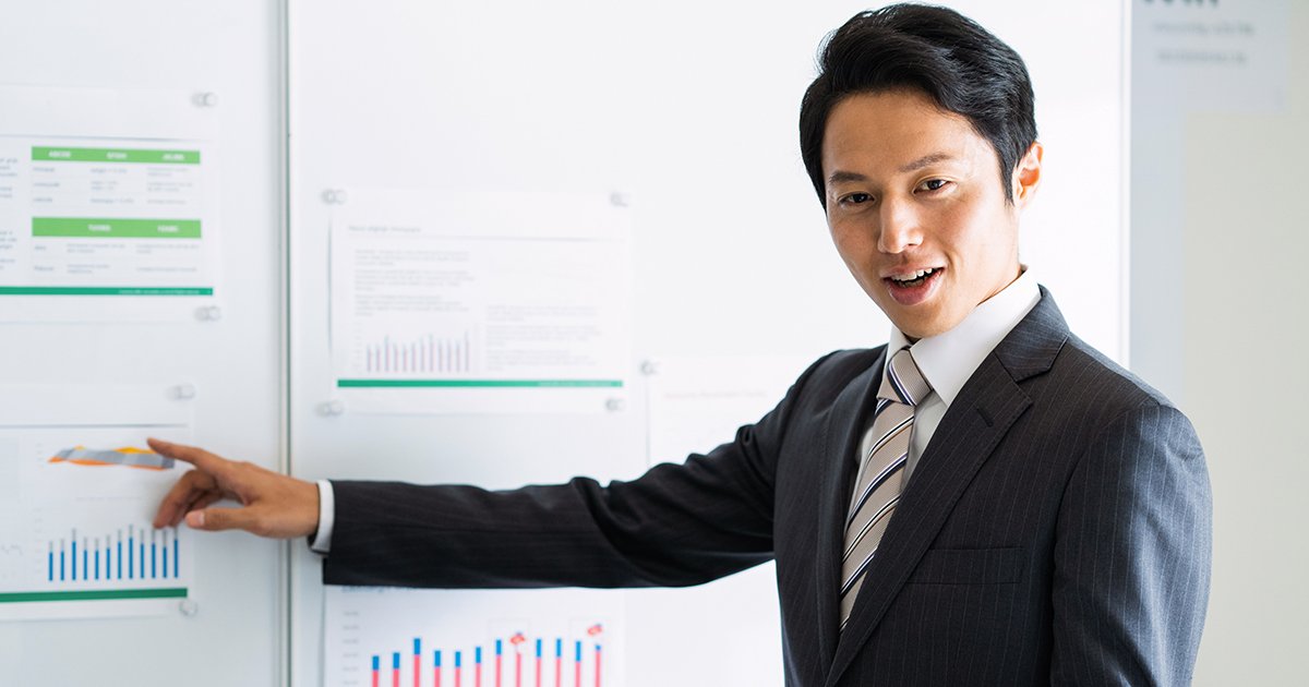 ホワイトボードの前でプレゼンするビジネスパーソン