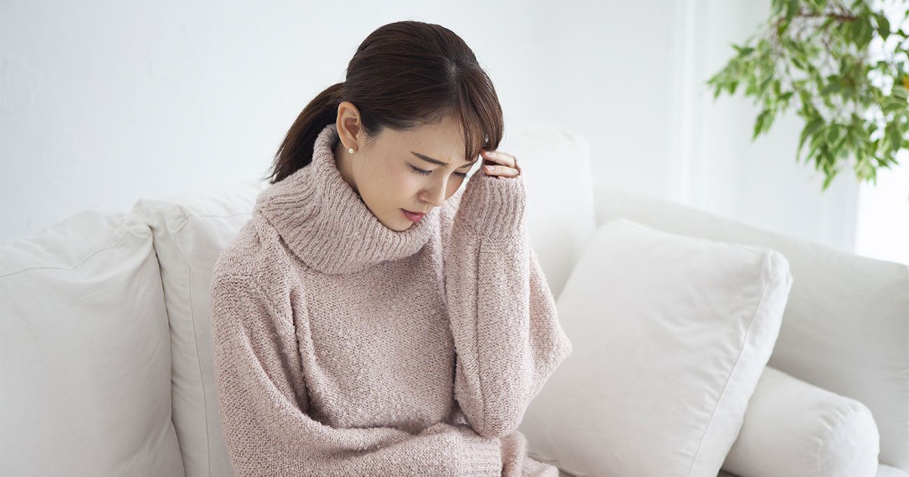 体調不良に悩む女性