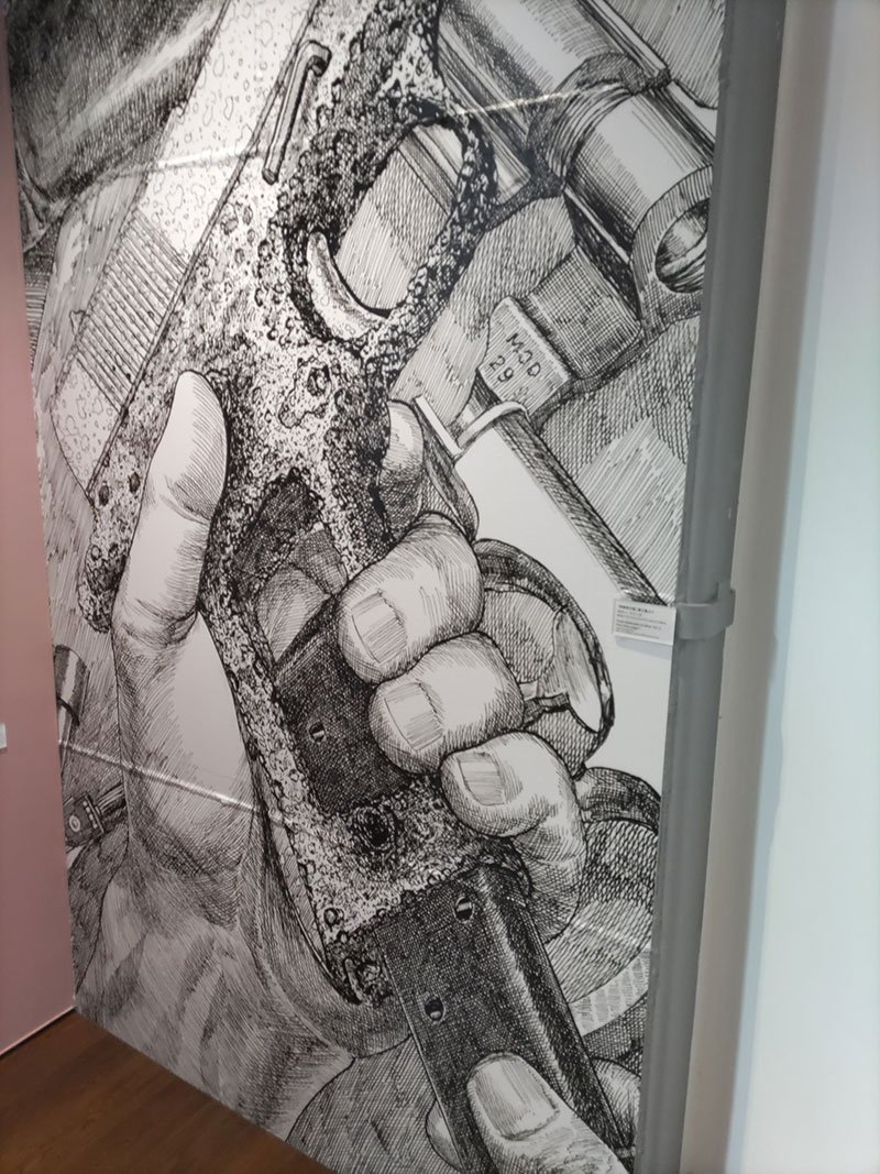 花輪和一が逮捕される原因となったと思われるモデルガンの絵の大きなパネル