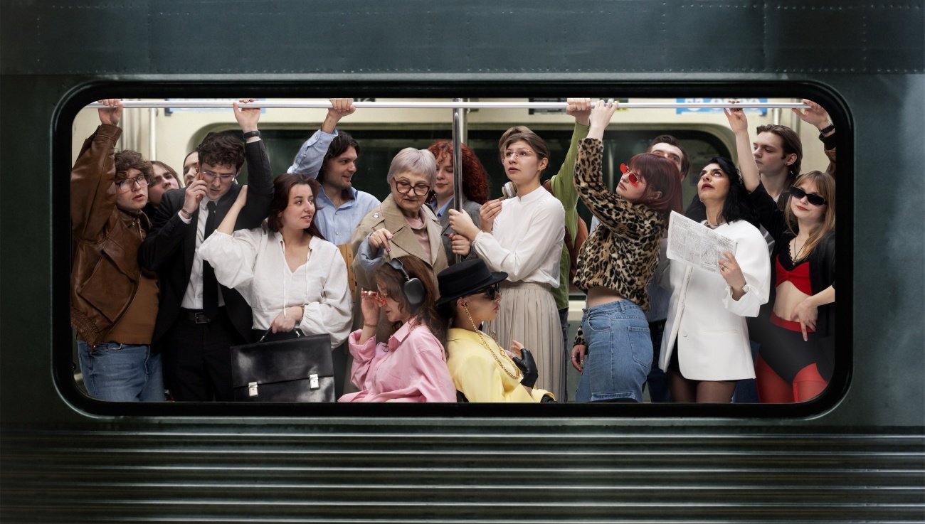 Diverse group of passengers standing crowded inside subway train holding overhead rail in urban environment. Concept of daily commute, public transport, city lifestyle and rush hour ... 