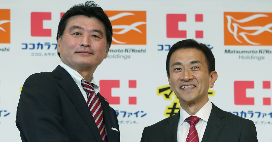 記者会見を終え握手するココカラファインの塚本厚志社長(右)とマツモトキヨシHDの松本清雄社長