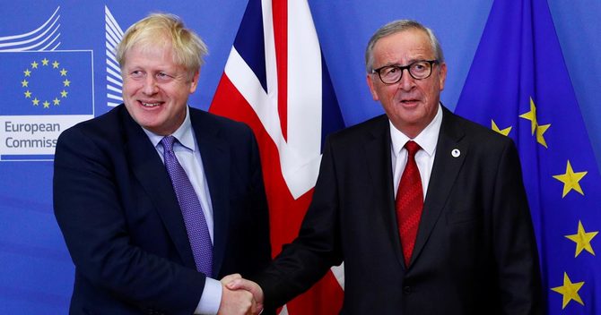 握手するジョンソン英首相とユンケル欧州委員長