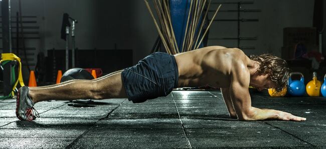 athletic man doing the plank for abs and core