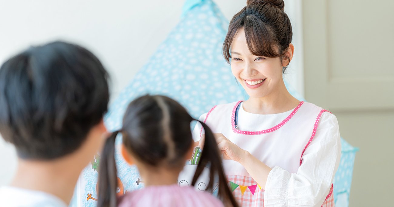子どもたちに絵本を読む保育士